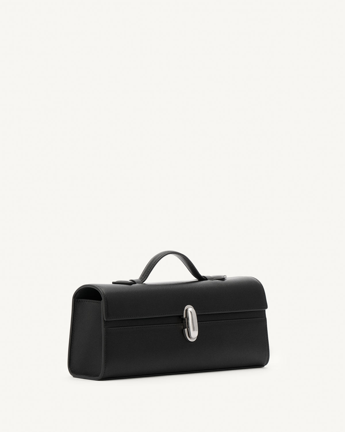 side view of vintage black leather top handle bag with matte silver clasp on a white background 
