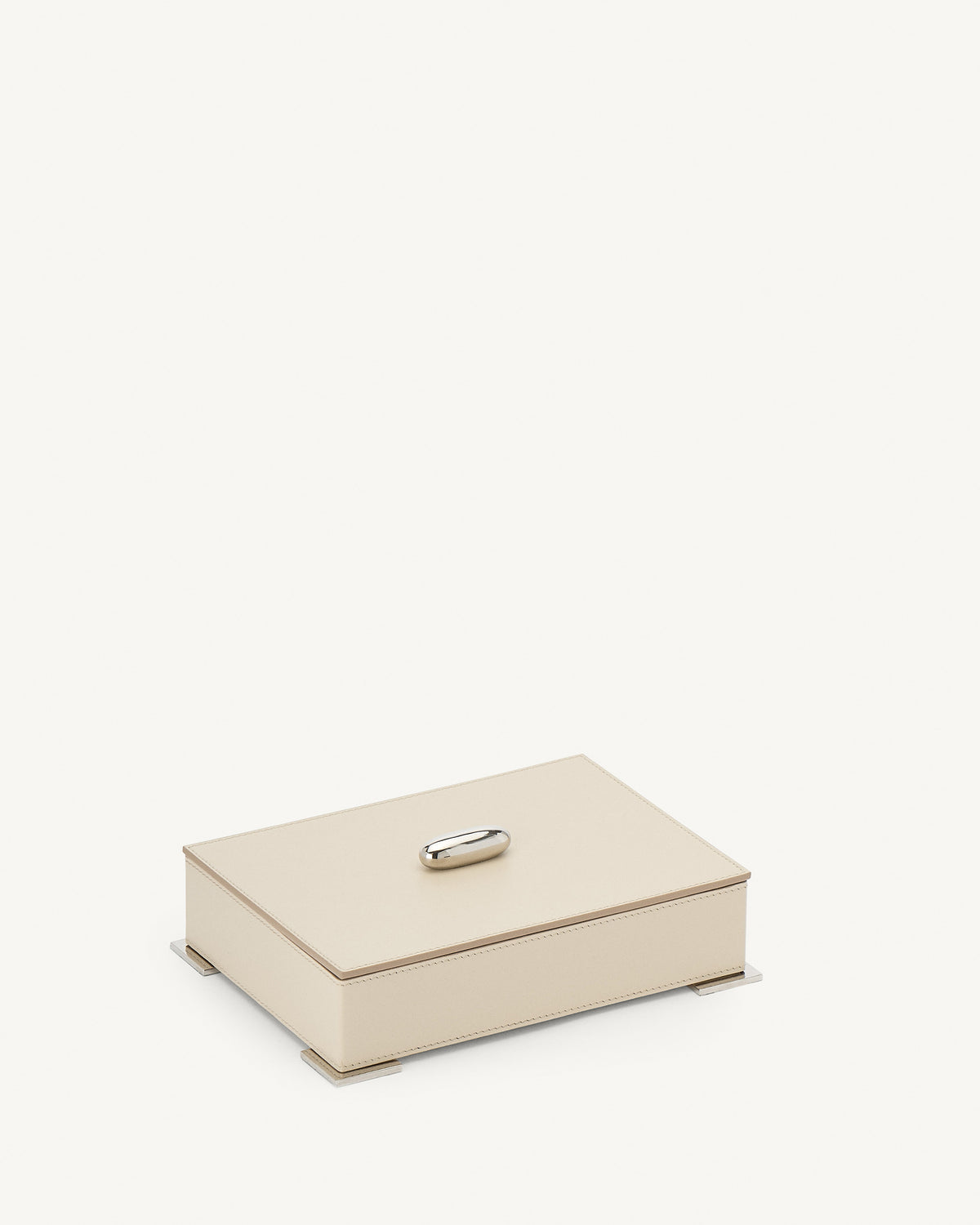 side view of a parchment beige leather box with silver metal hardware on a white background