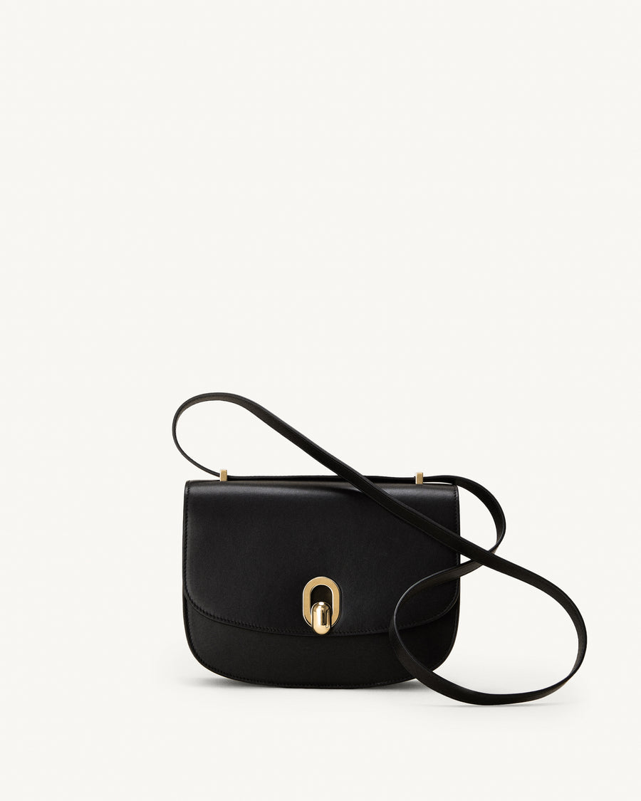 front view of a black leather bag with gold hardware on a white background