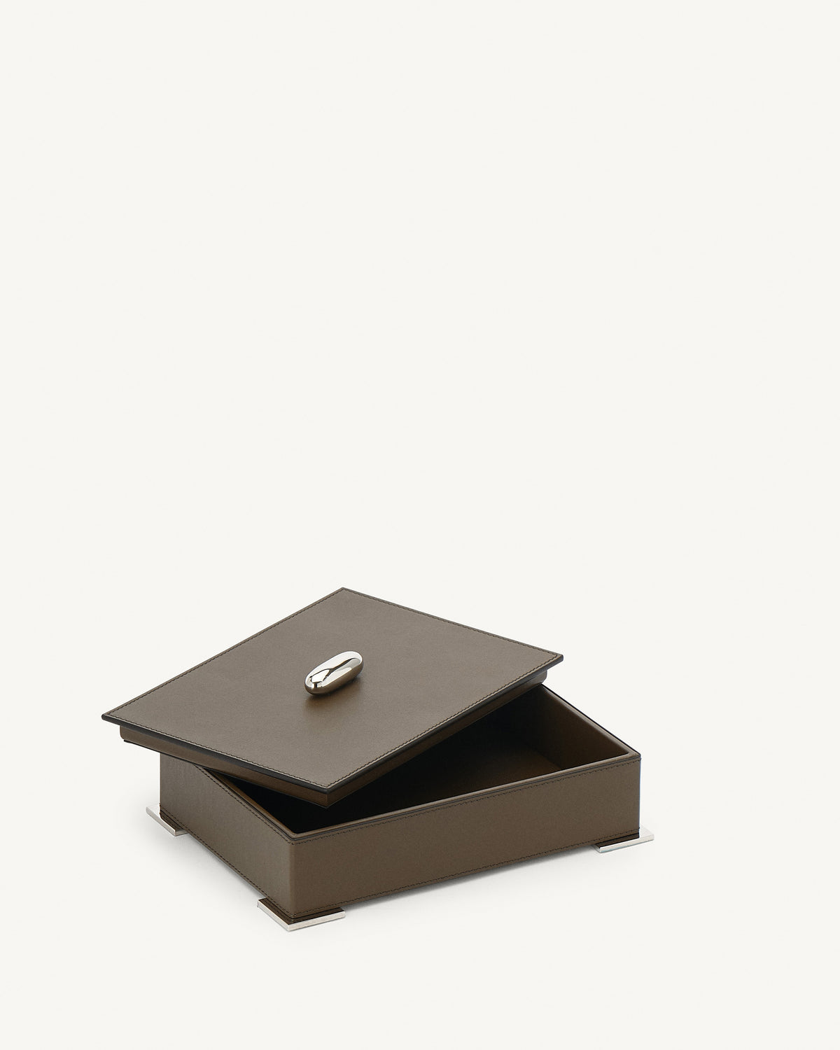 interior view of a mink brown leather box with silver hardware on a white background