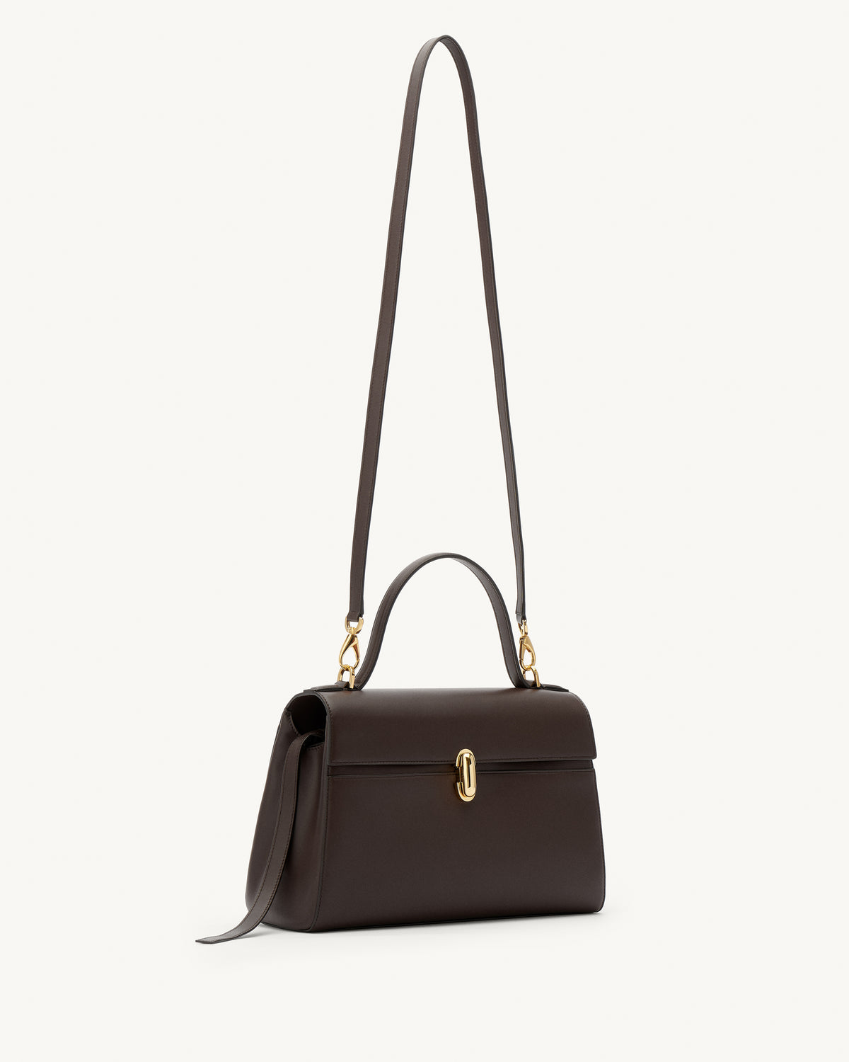 side view of a coffee brown leather bag with a gold clasp on a white background