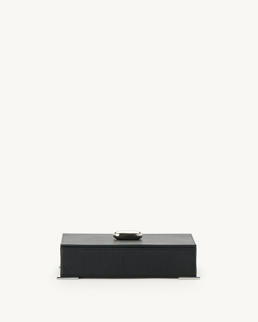 front view of a an ebony black leather box with silver hardware  on a white background