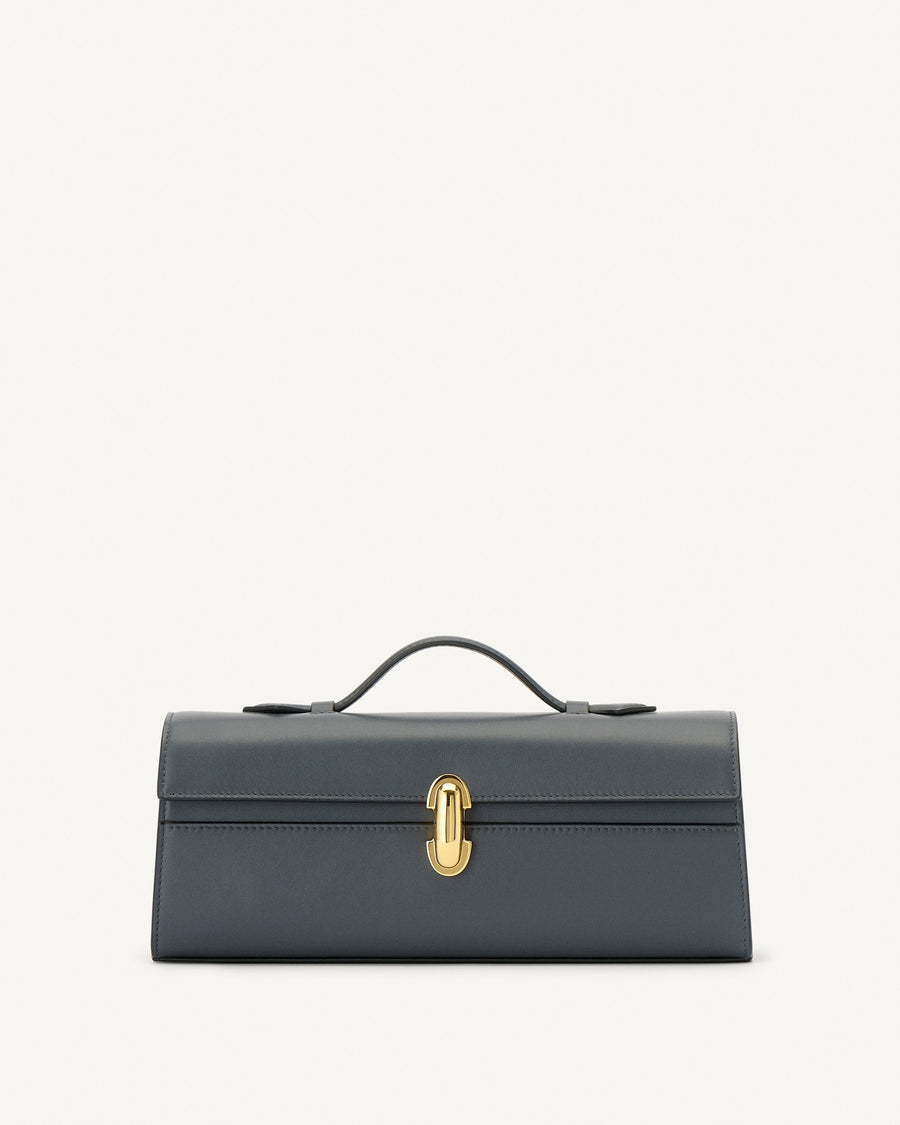 front view of a storm blue leather bag with a gold clasp on a white background