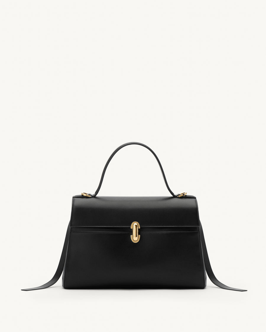 front view of a black leather handbag with gold clasp on a white background 