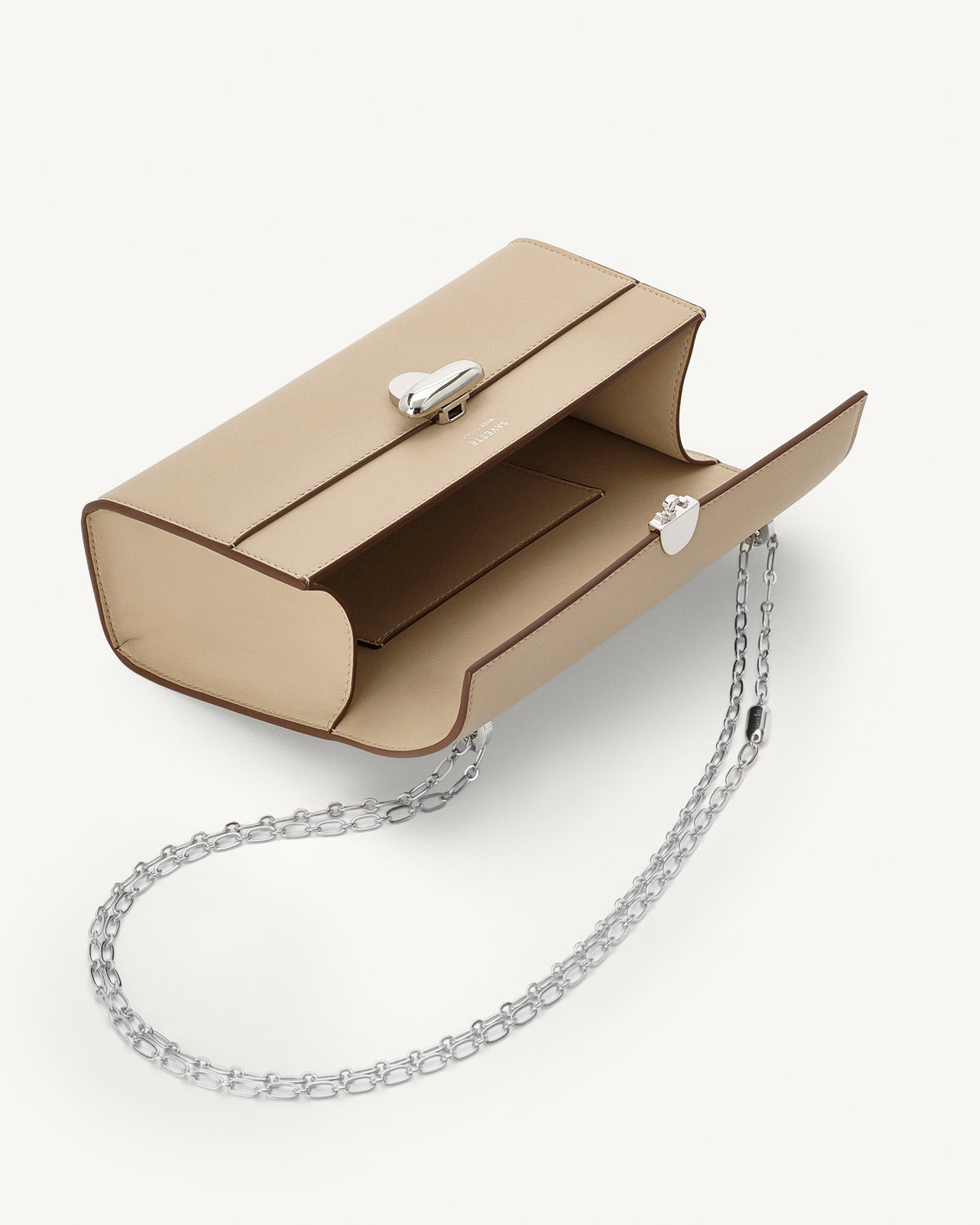 inside view of bone beige bag with silver clasp and silver chain on a white background