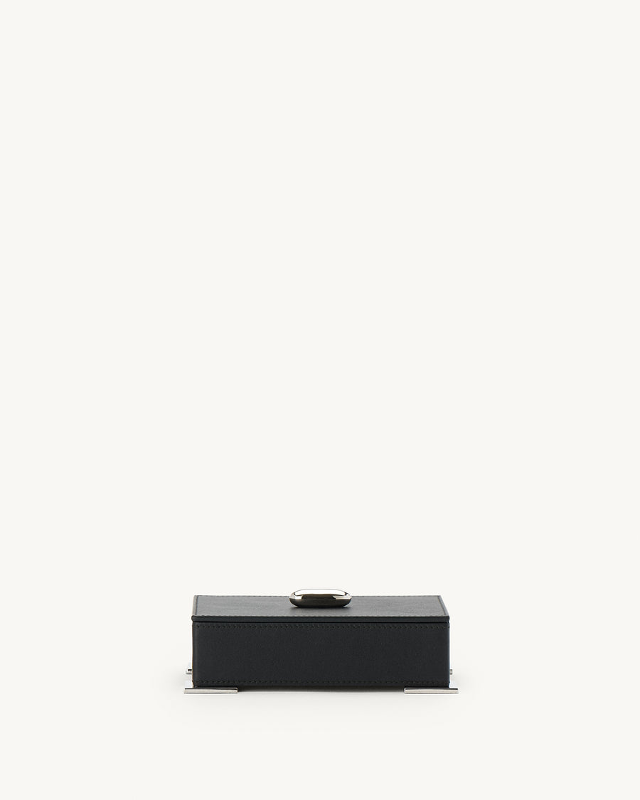 front view of a an ebony black leather box with silver hardware  on a white background