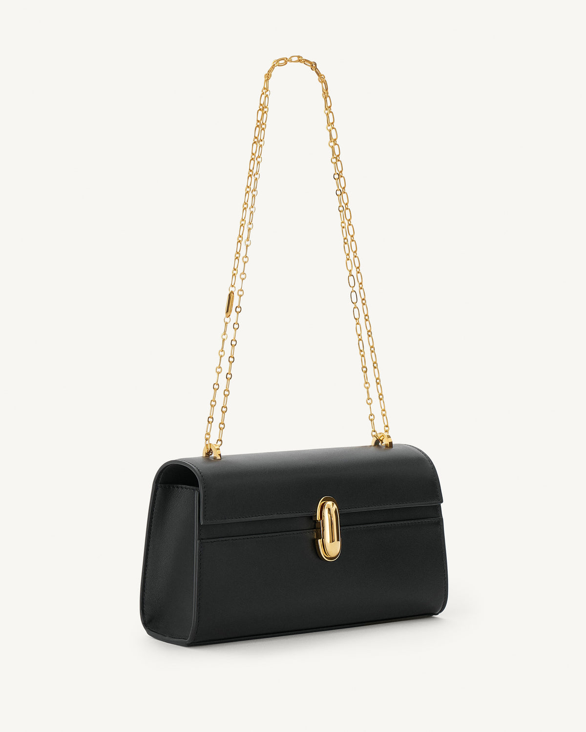 side view of black bag with gold clasp and gold chain on a white background