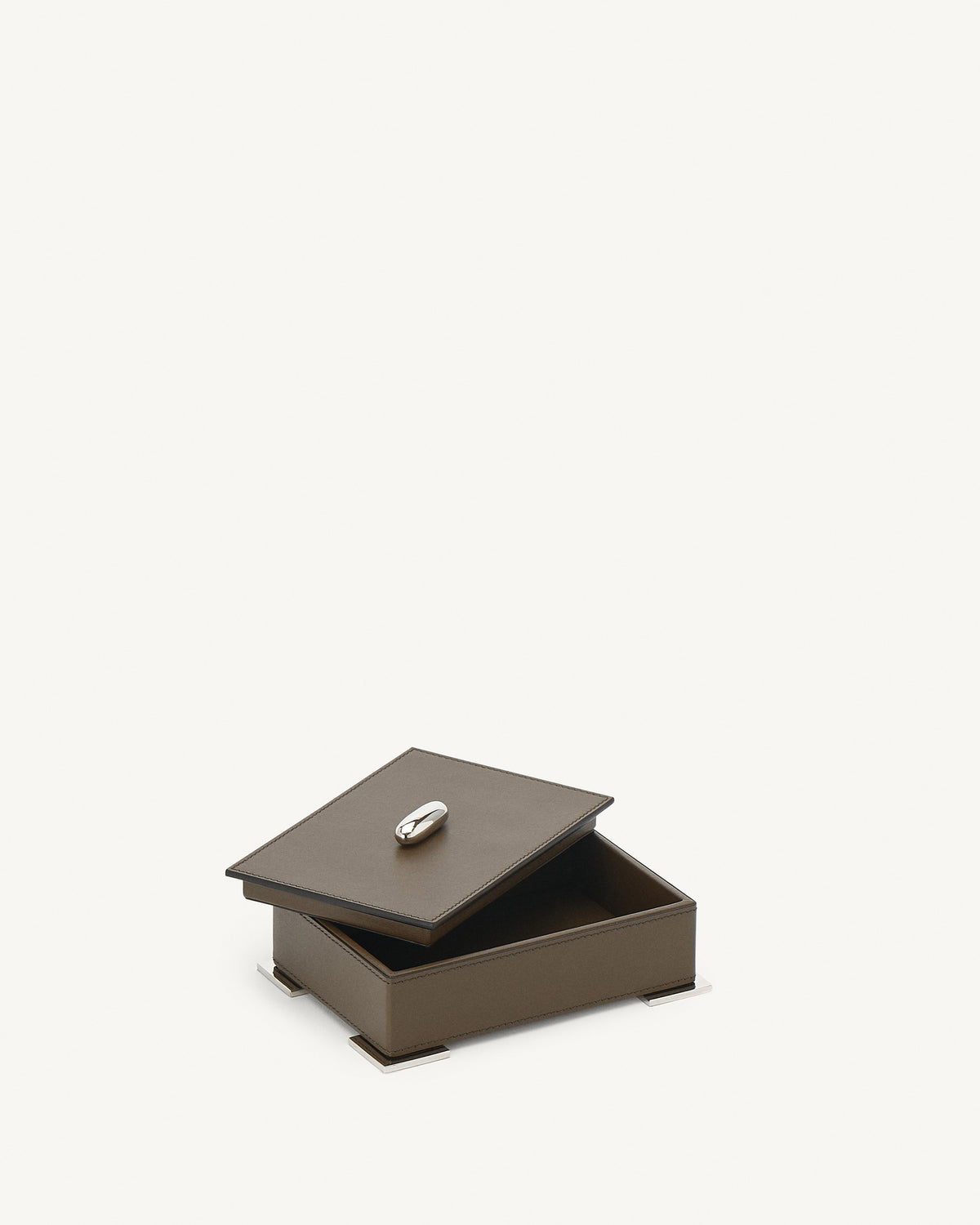 interior view of a mink brown leather box with silver hardware on a white background