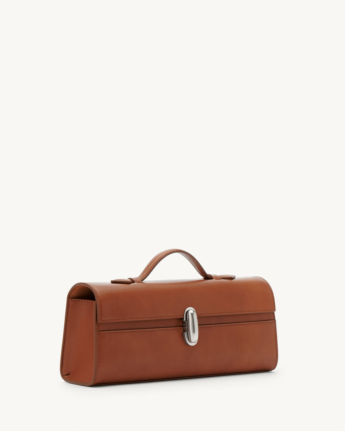 side view of a cognac brown leather top handle bag with a silver clasp on a white background 