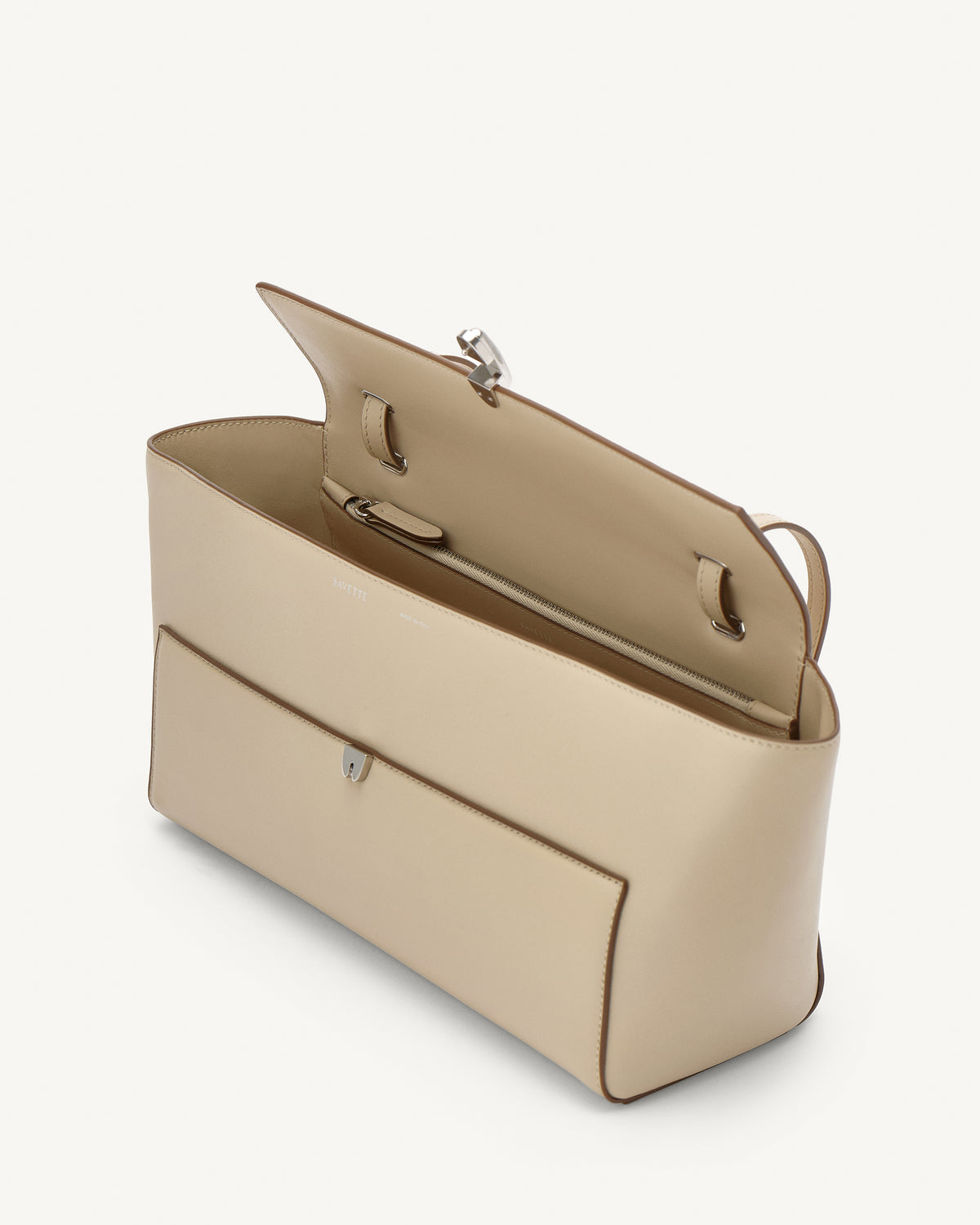 side view of a bone beige leather bag with a silver clasp on a white background