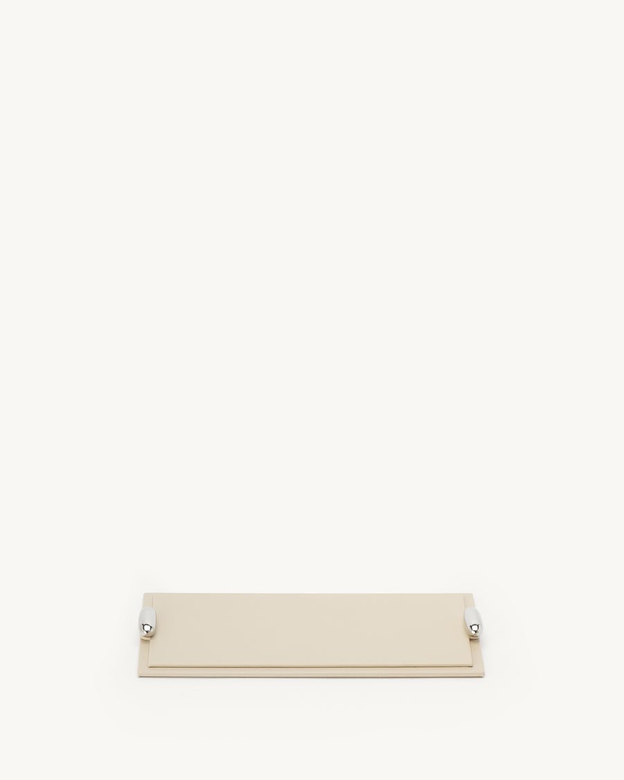 front view of a parchment beige leather tray with silver hardware on a white background