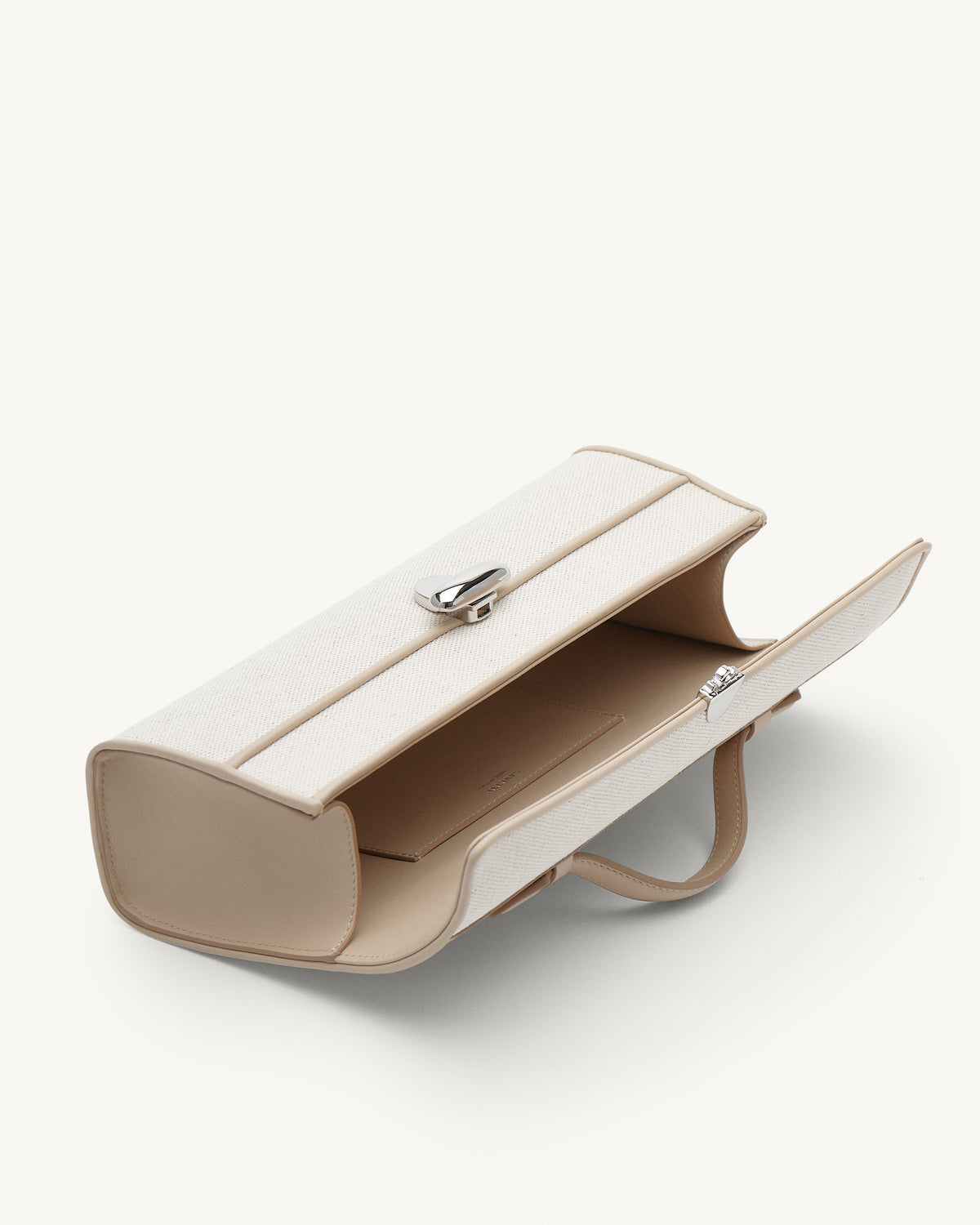 Inside view of Beige handbag with a silver clasp on a white background