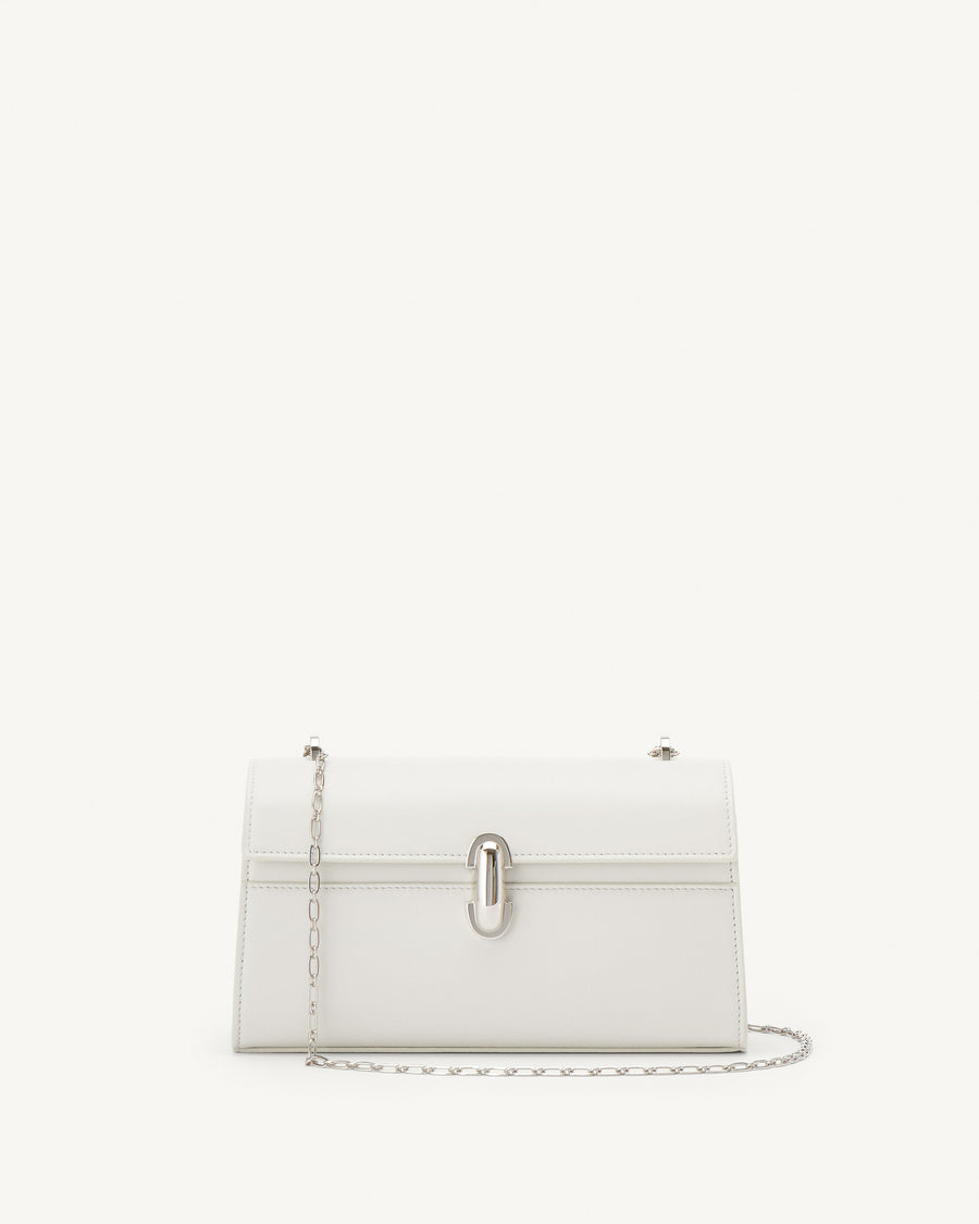 front view of an ivory leather bag with silver clasp and silver chain on a white background