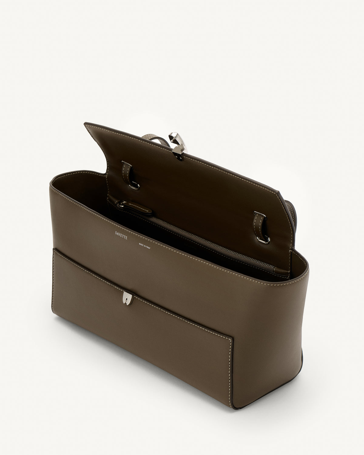 interior view of a mink brown leather bag with a silver clasp on a white background