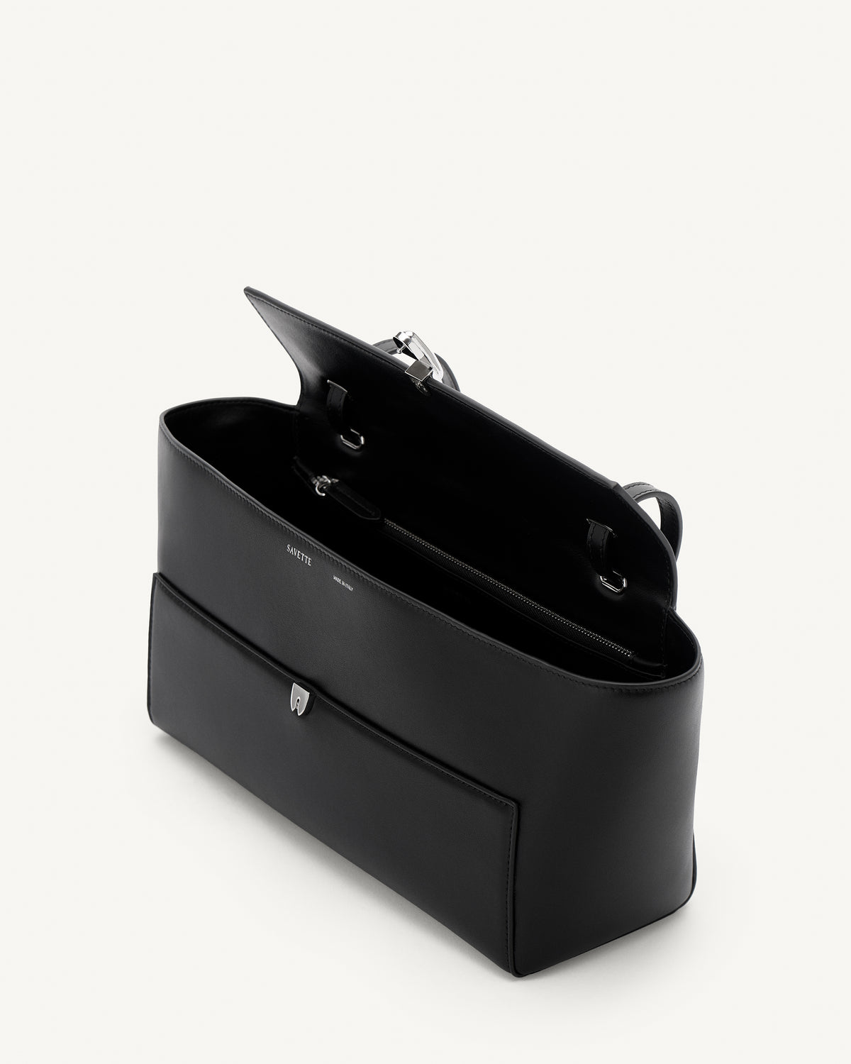 interior view of black leather bag with a silver clasp on a white background