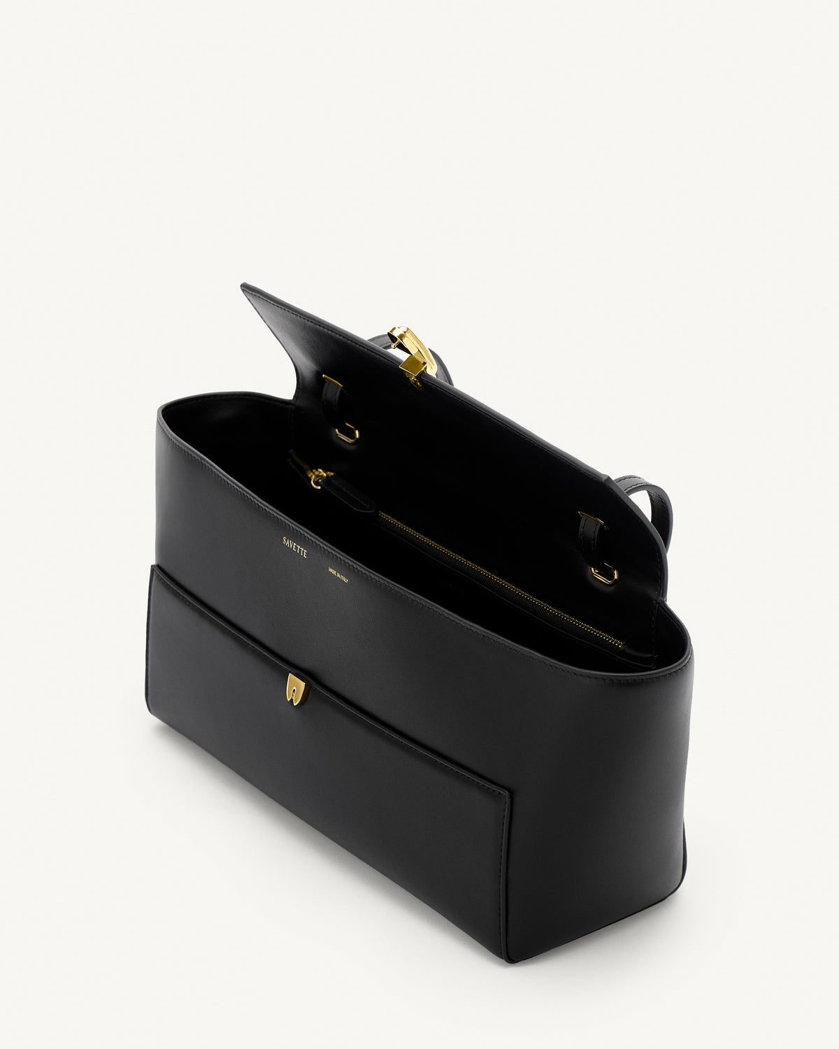 interior view of a black leather bag with a gold clasp on a white background 