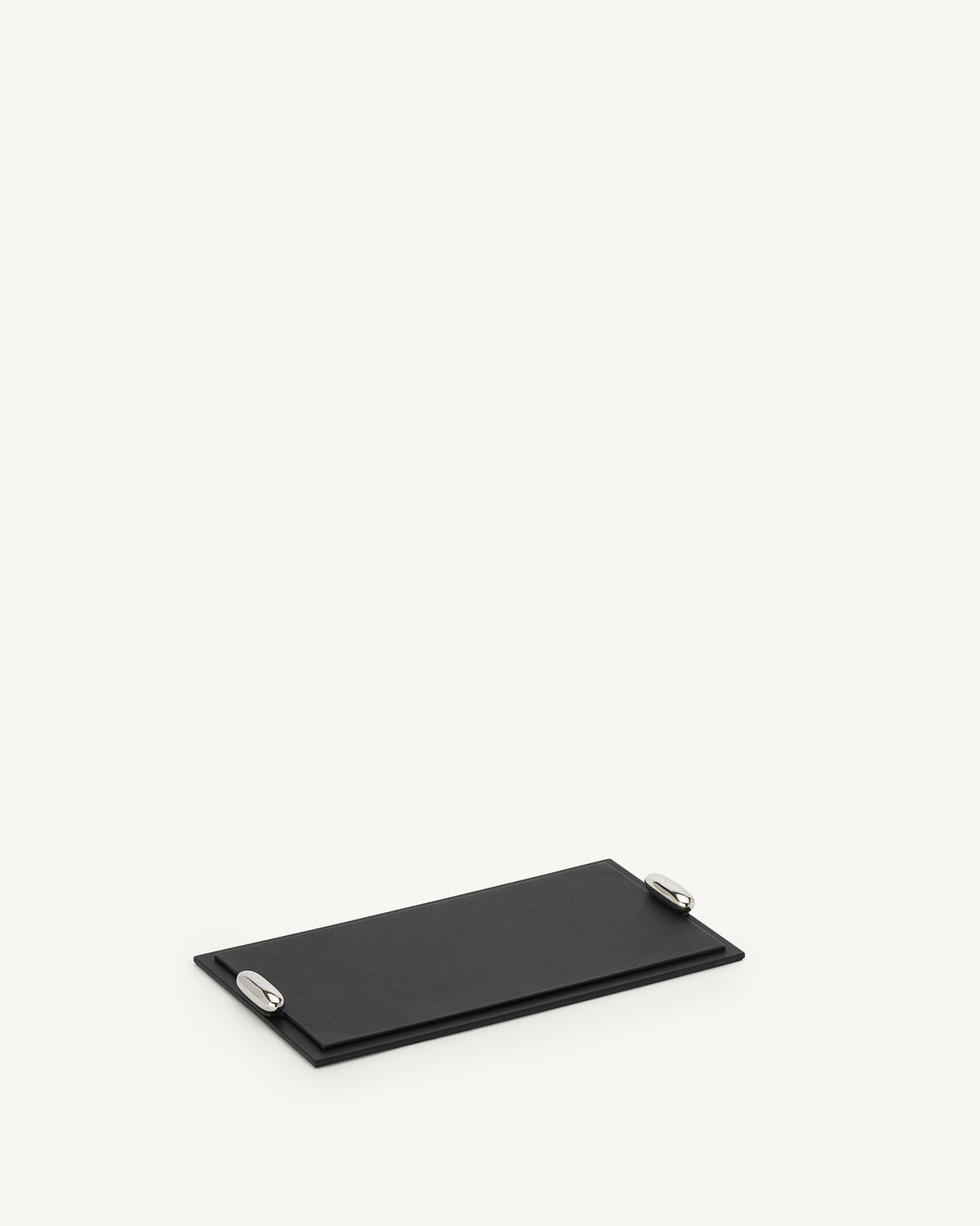 side view of an ebony black leather tray with silver hardware on a white background