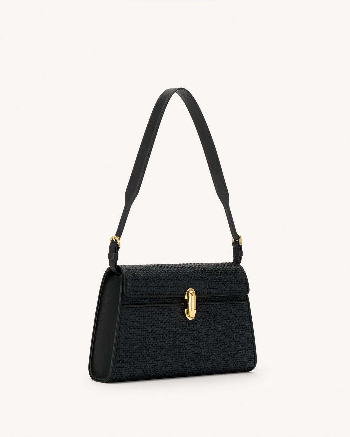 side view of a black raffia bag with leather trim with a gold clasp on a white background