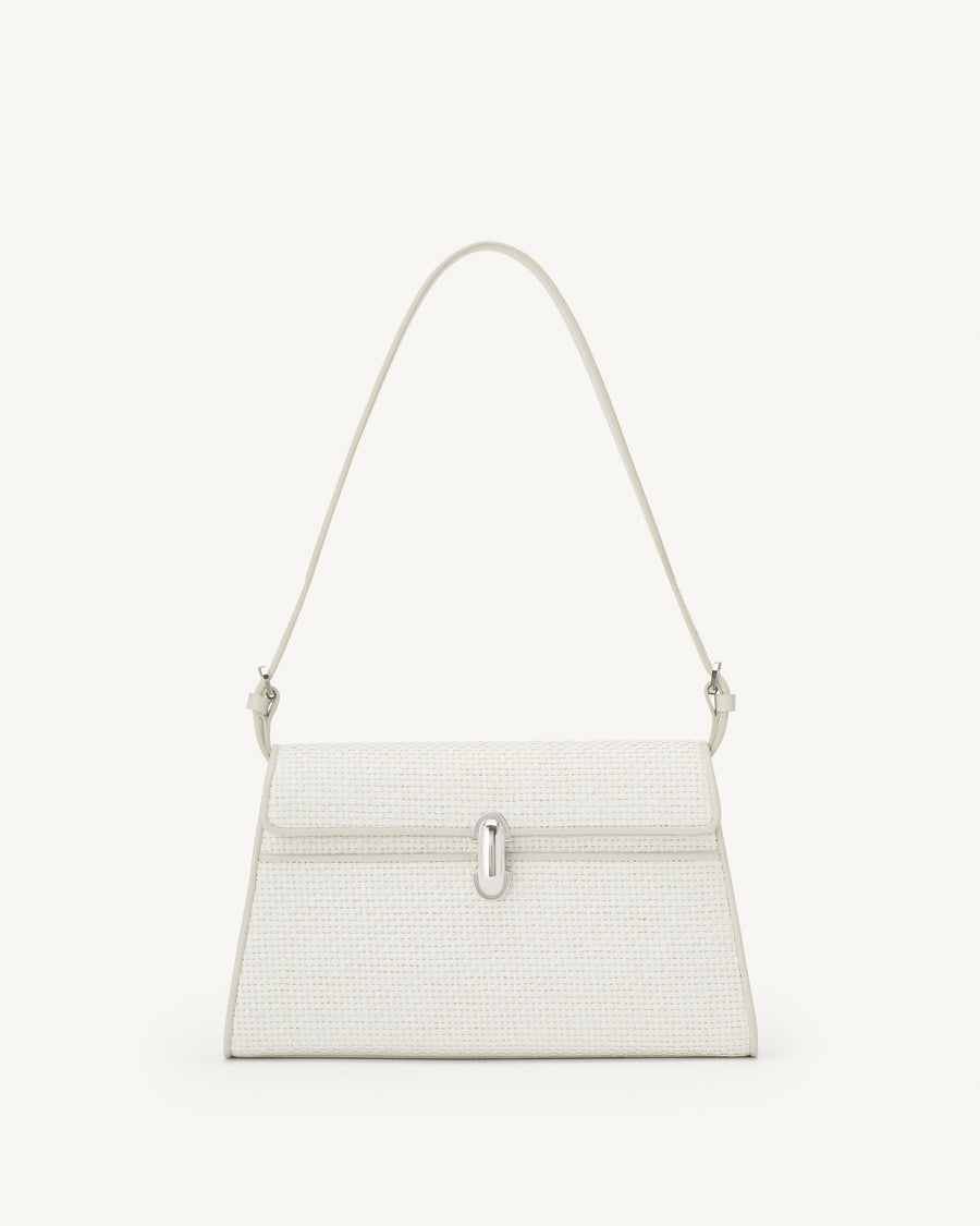 front view of a white raffia bag with leather trim and silver clasp on a white background