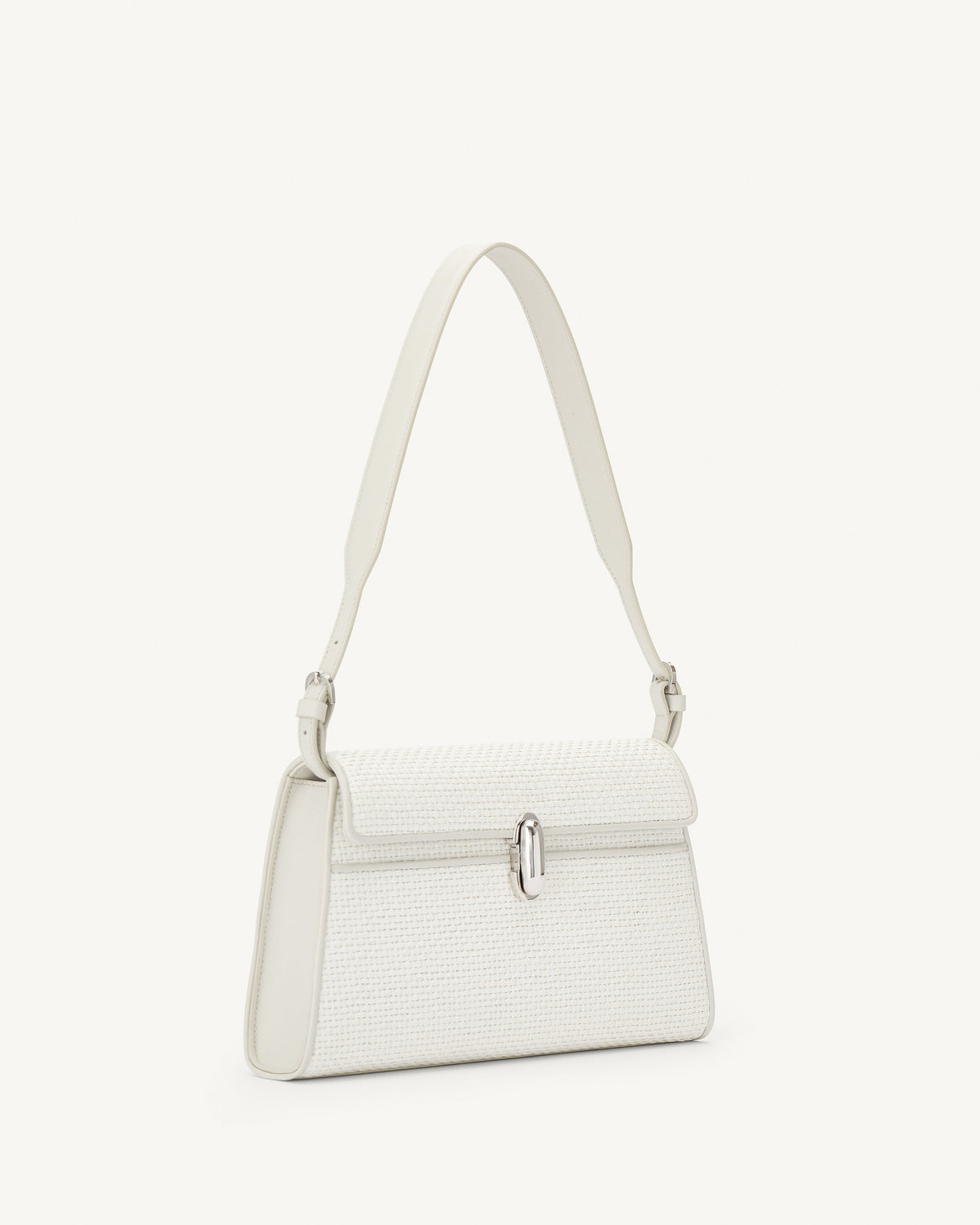 side view of a white raffia bag with leather trim and silver clasp on a white background