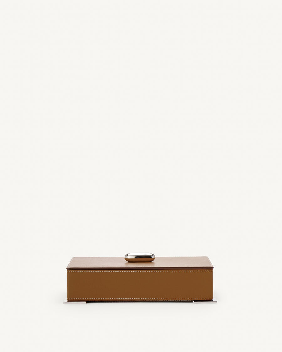 front view of a saddle brown leather box with silver hardware on a white background