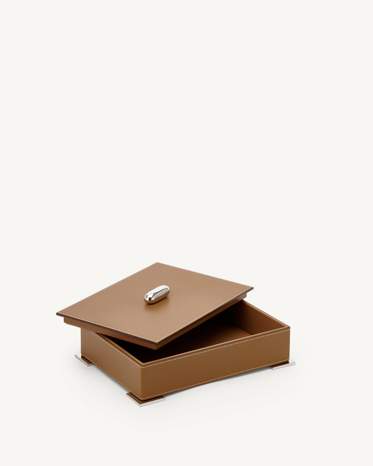 interior view of a saddle brown leather box with silver hardware on a white background
