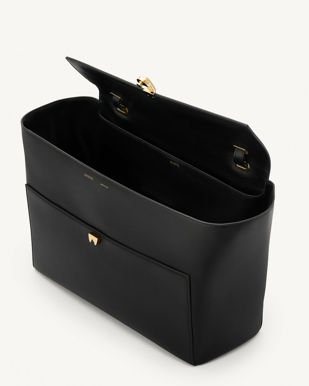 interior view of a black leather tote bag with a gold clasp on a white background 