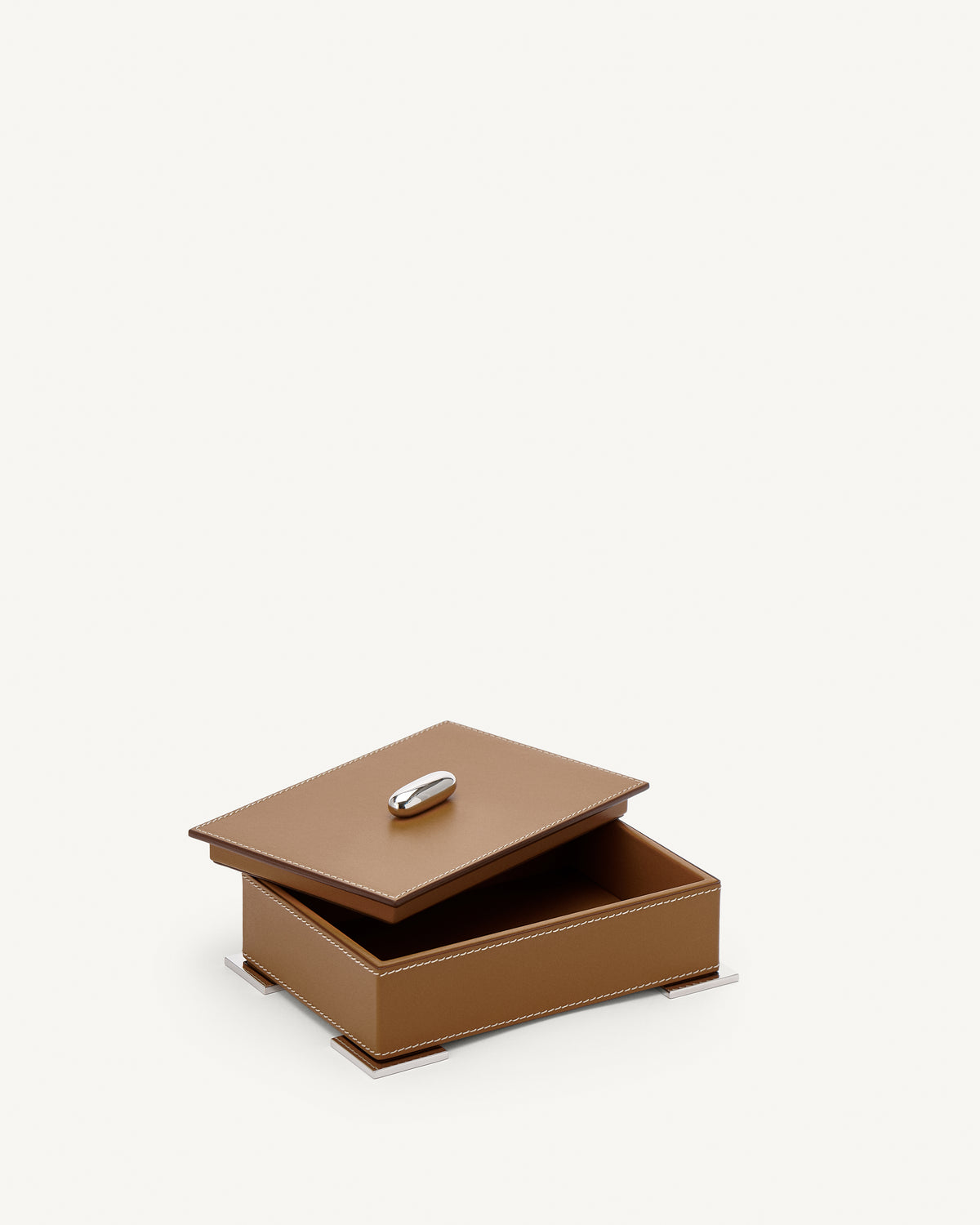 interior view of a saddle brown leather box with silver hardware on a white background