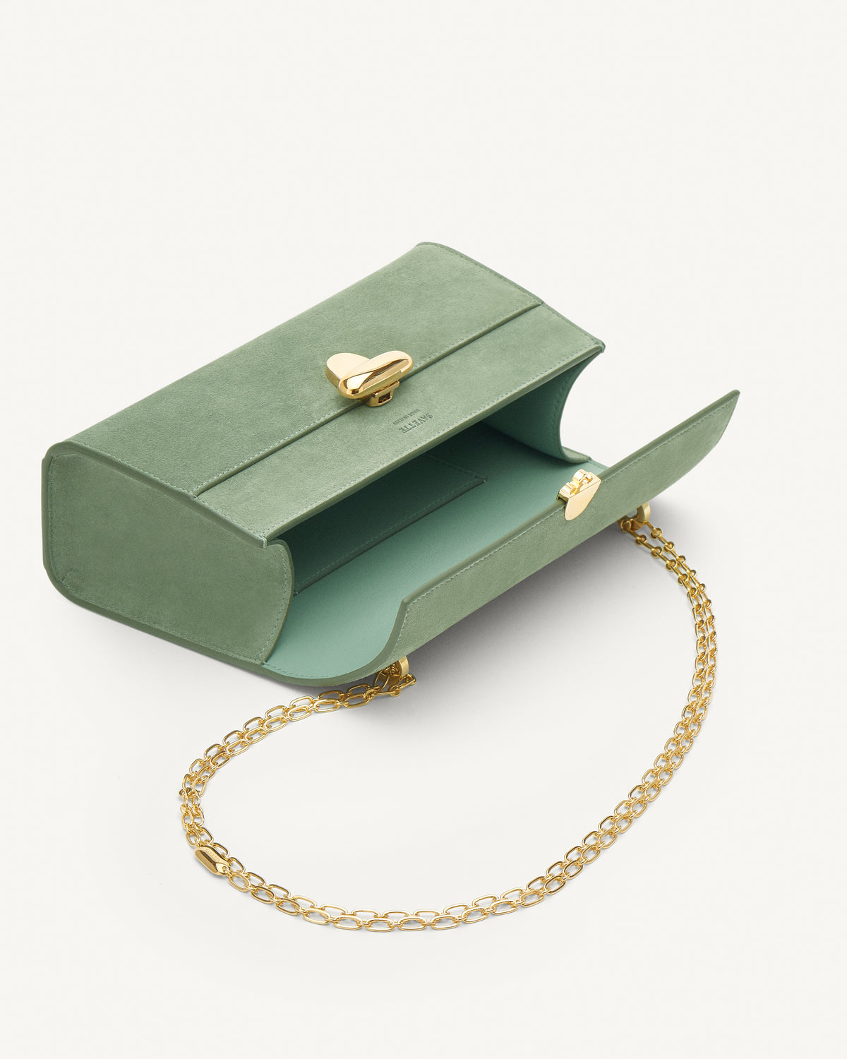 Inside view of cactus suede handbag with a gold chain on a white background