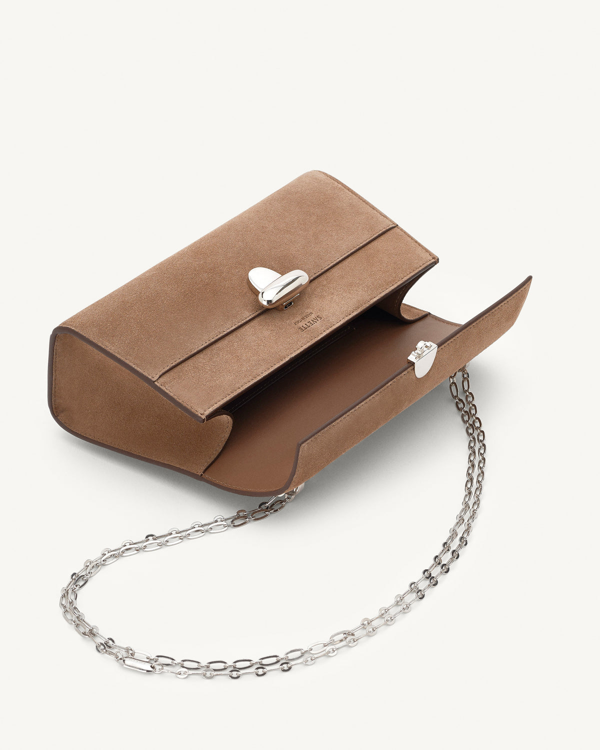 interior view of a taupe brown suede bag with silver clasp and silver chain on a white background