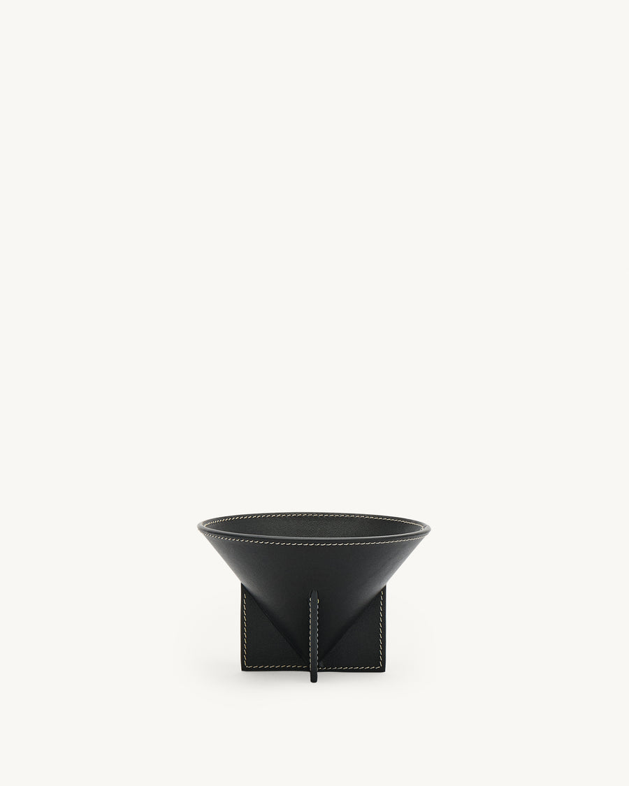 front view of an ebony black leather dish with white stitching on a white background