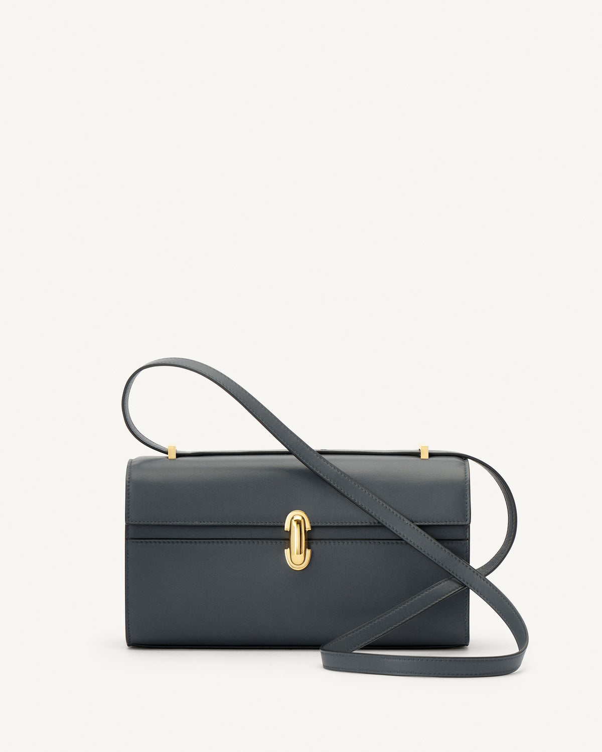 front view of a storm blue leather bag with a gold clasp on a white background