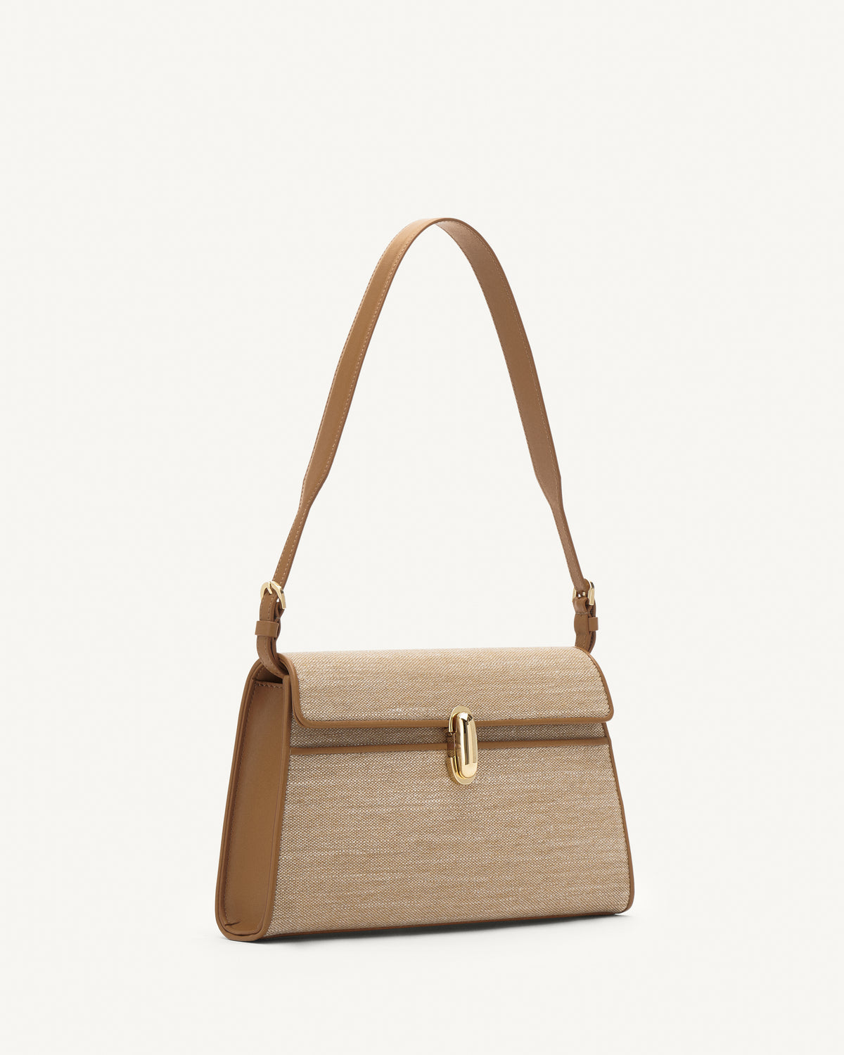 Side view of beige canvas shoulder bag with gold hardware