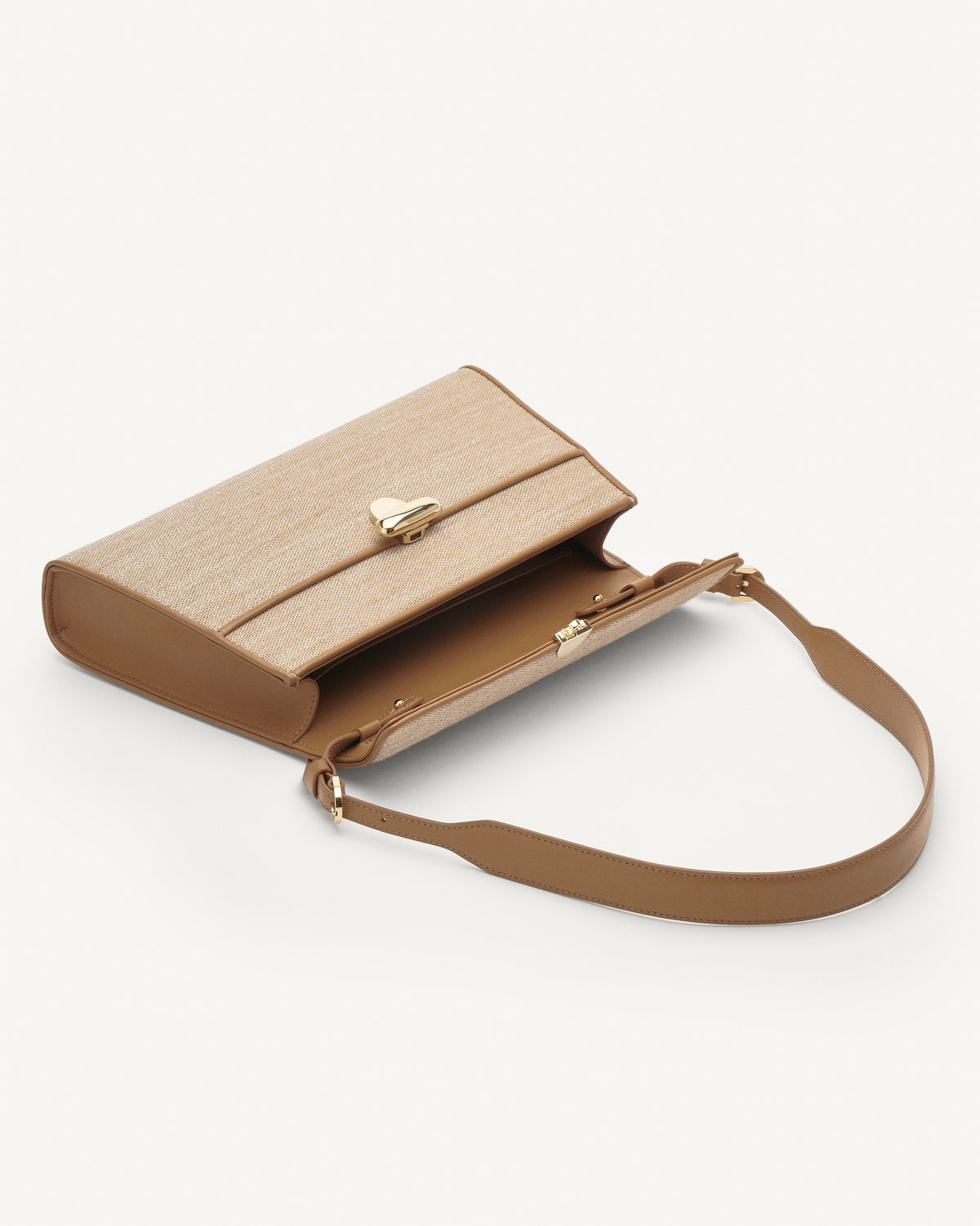 Inside view of beige canvas shoulder bag with gold hardware