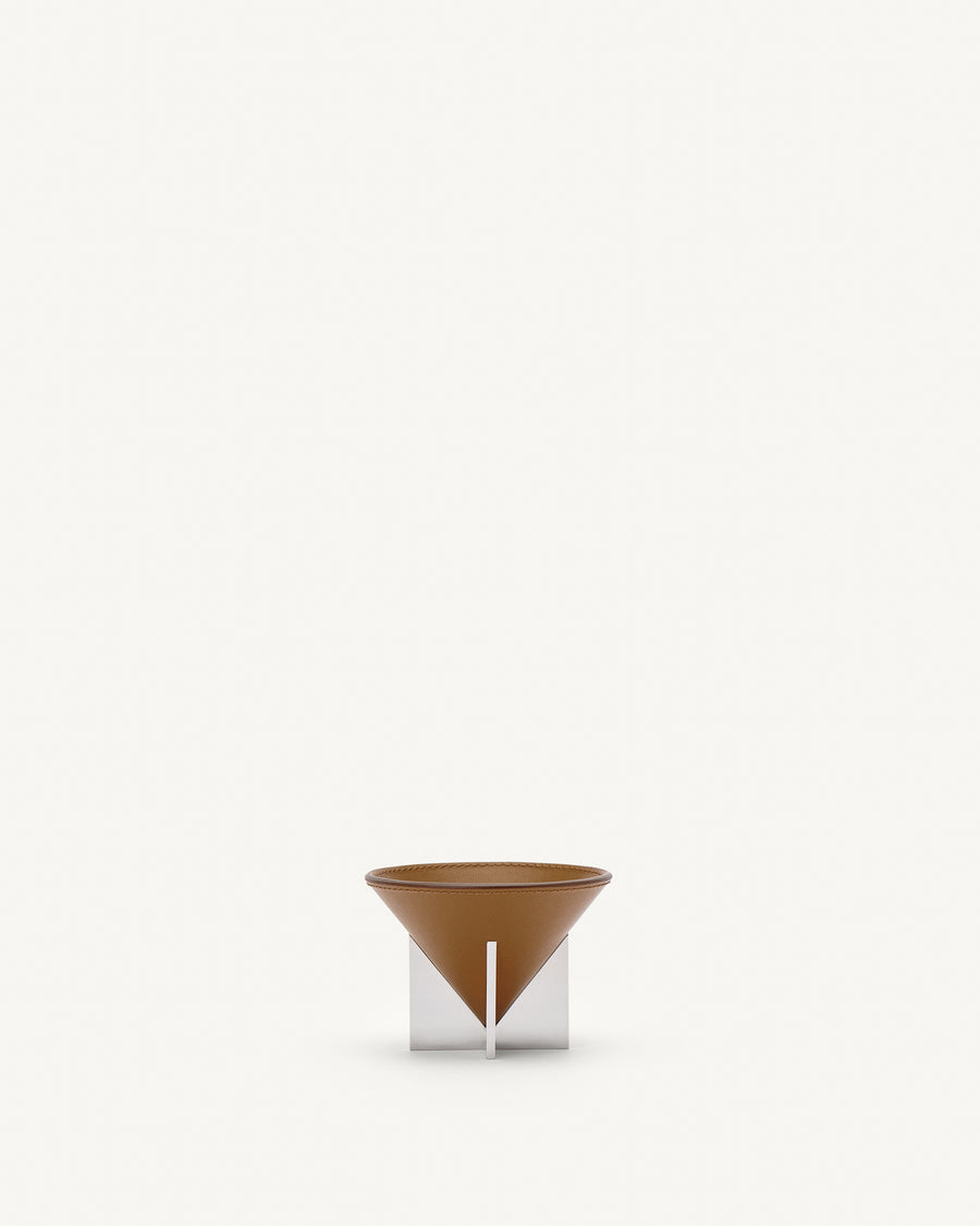 front view of a saddle brown leather dish with silver metal feet on a white background