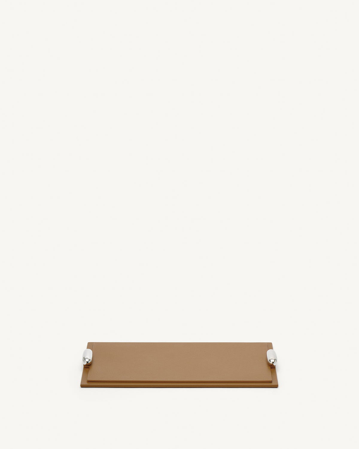 front view of a saddle brown leather tray with silver hardware on a white background