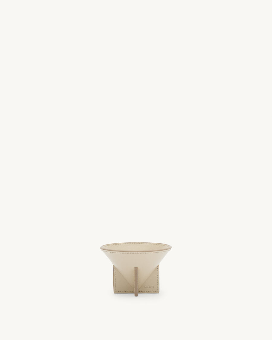 front view of a parchment beige leather dish on a white background