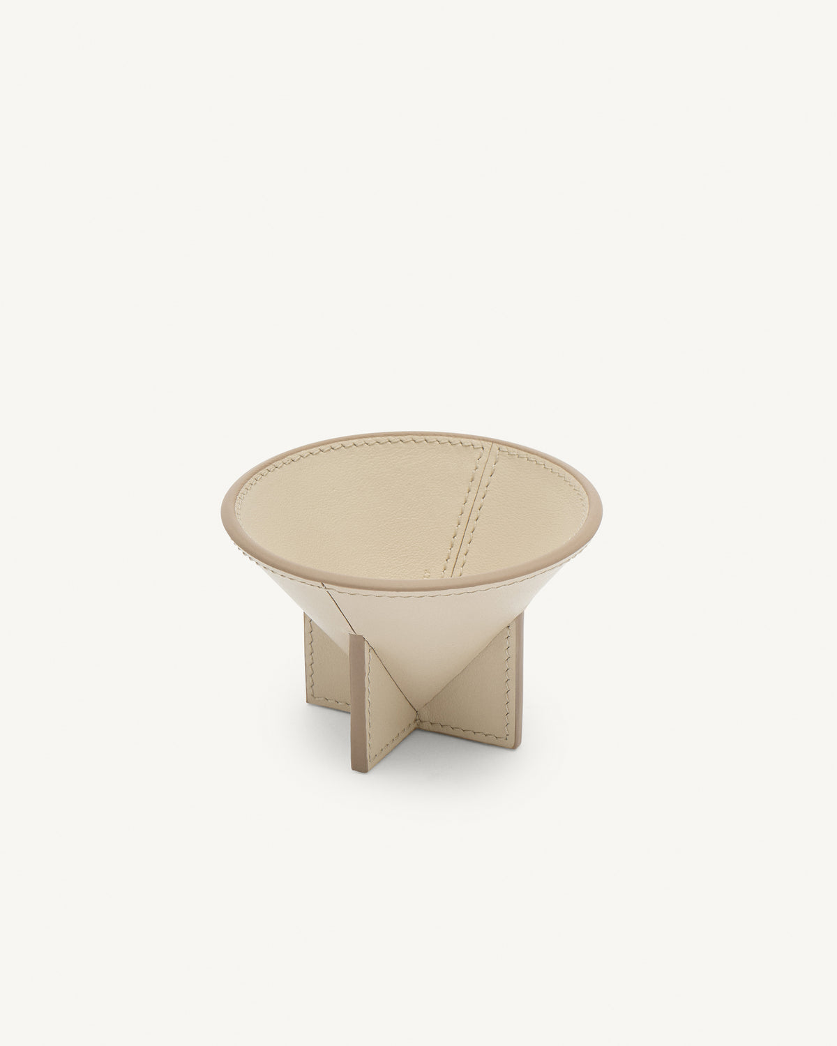 interior view of a parchment beige leather dish on a white background