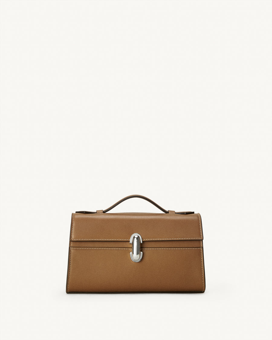 front view of a saddle brown leather bag with a silver clasp on a white background