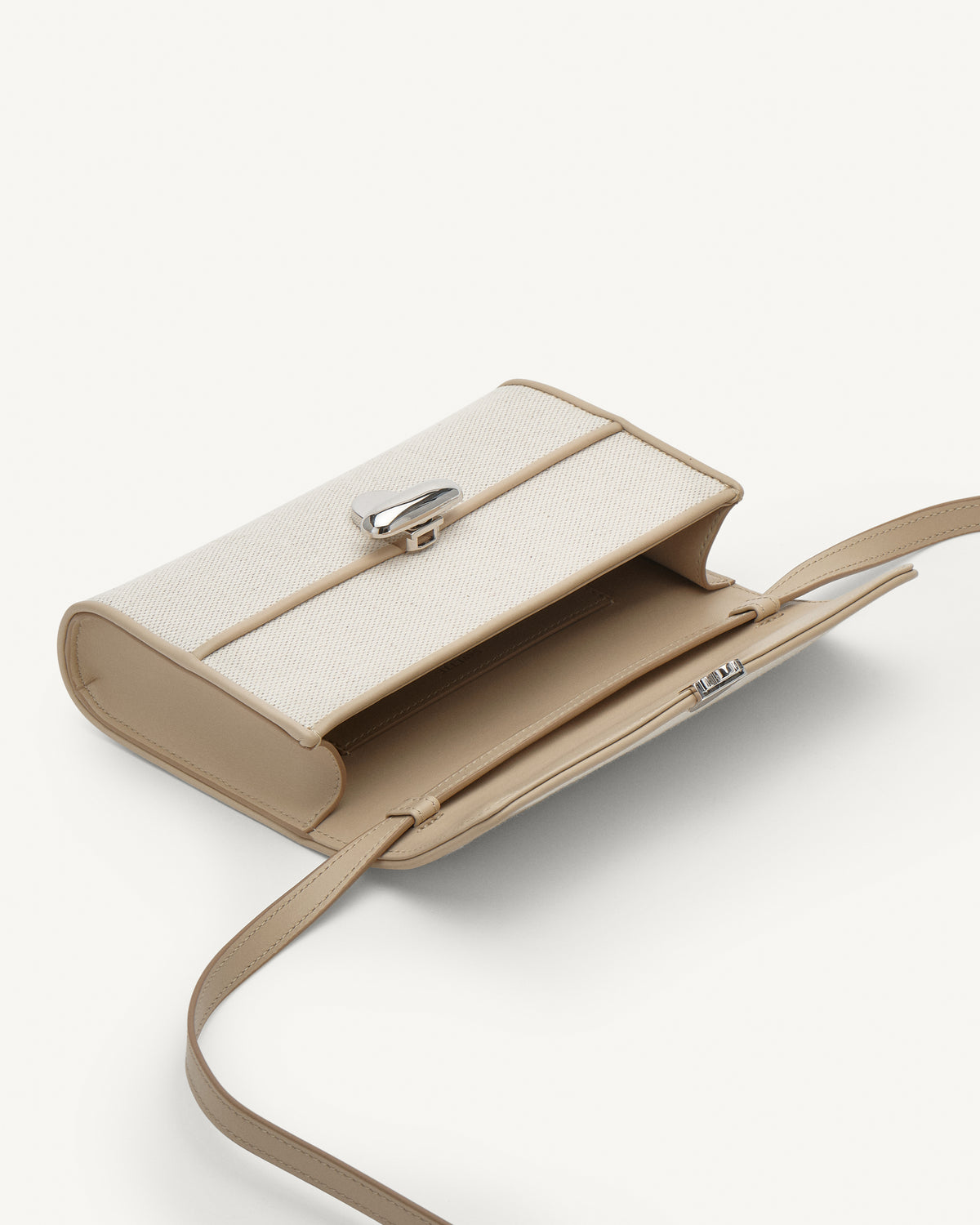 Inside view of white canvas crossbody with silver hardware