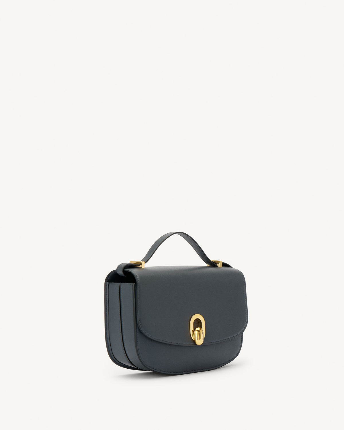 side view of a storm blue leather bag with gold hardware on a white background