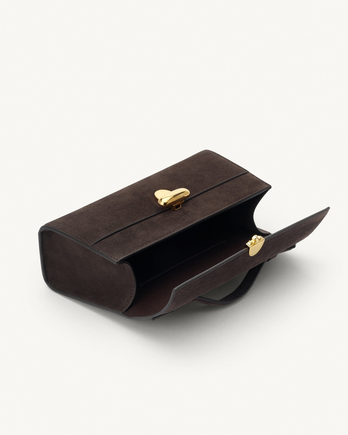interior view of a coffee brown suede top handle bag with a gold clasp on a white background