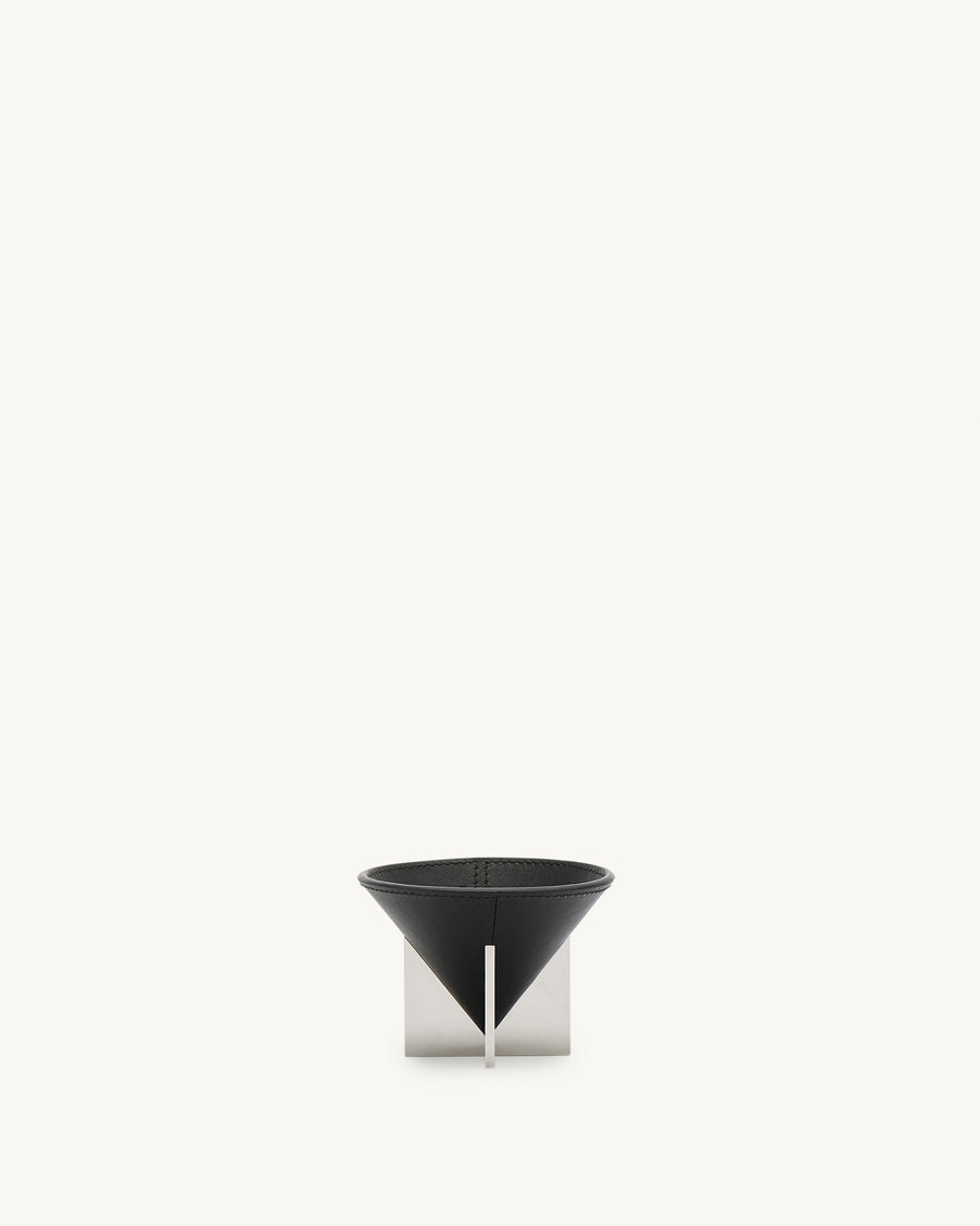 front view of a small ebony black leather dish with silver metal feet on a white background