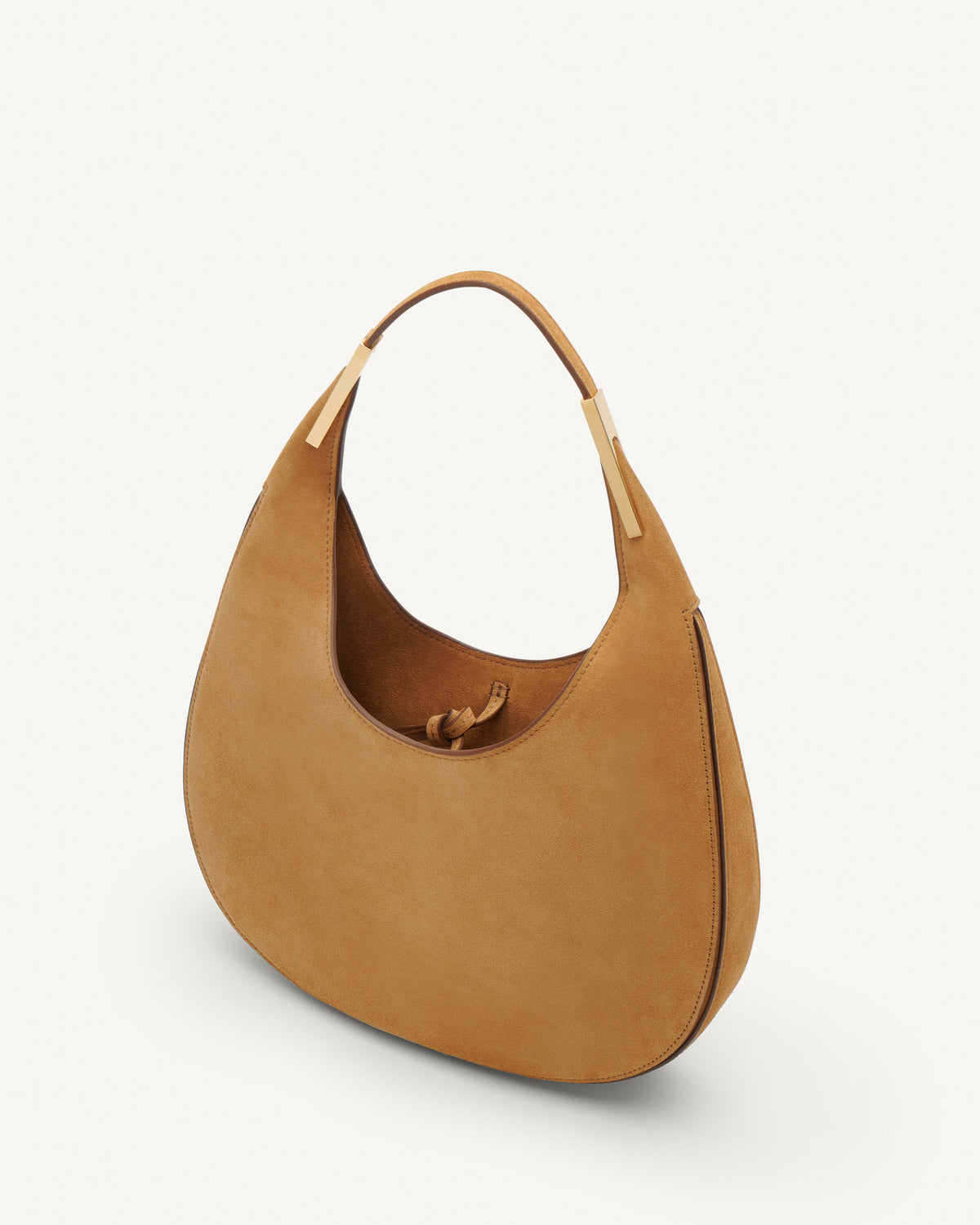 Inside view of saddle suede small tote bag with gold hardware on a white background