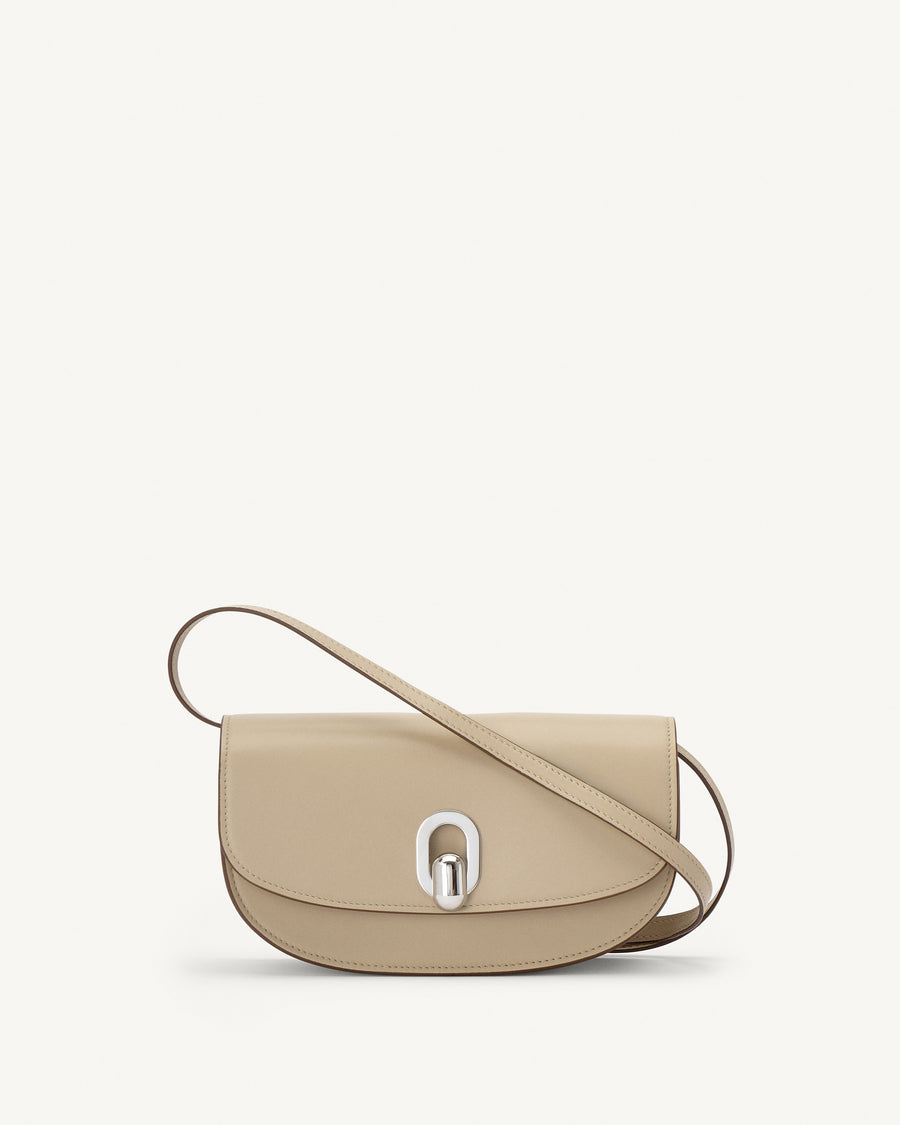 front view of a bone beige leather bag with silver hardware on a white background