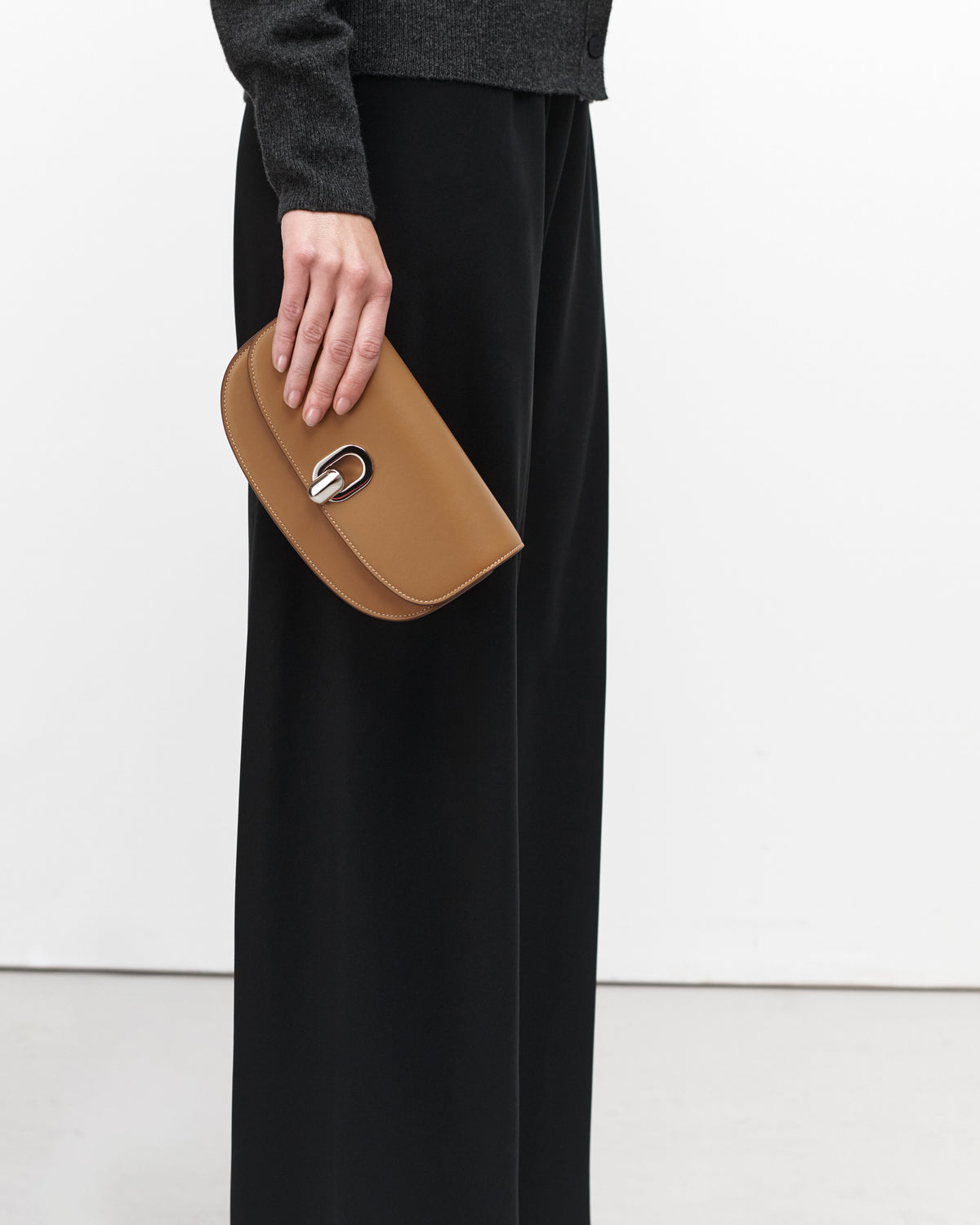 On model view of saddle leather crossbody with silver hardware