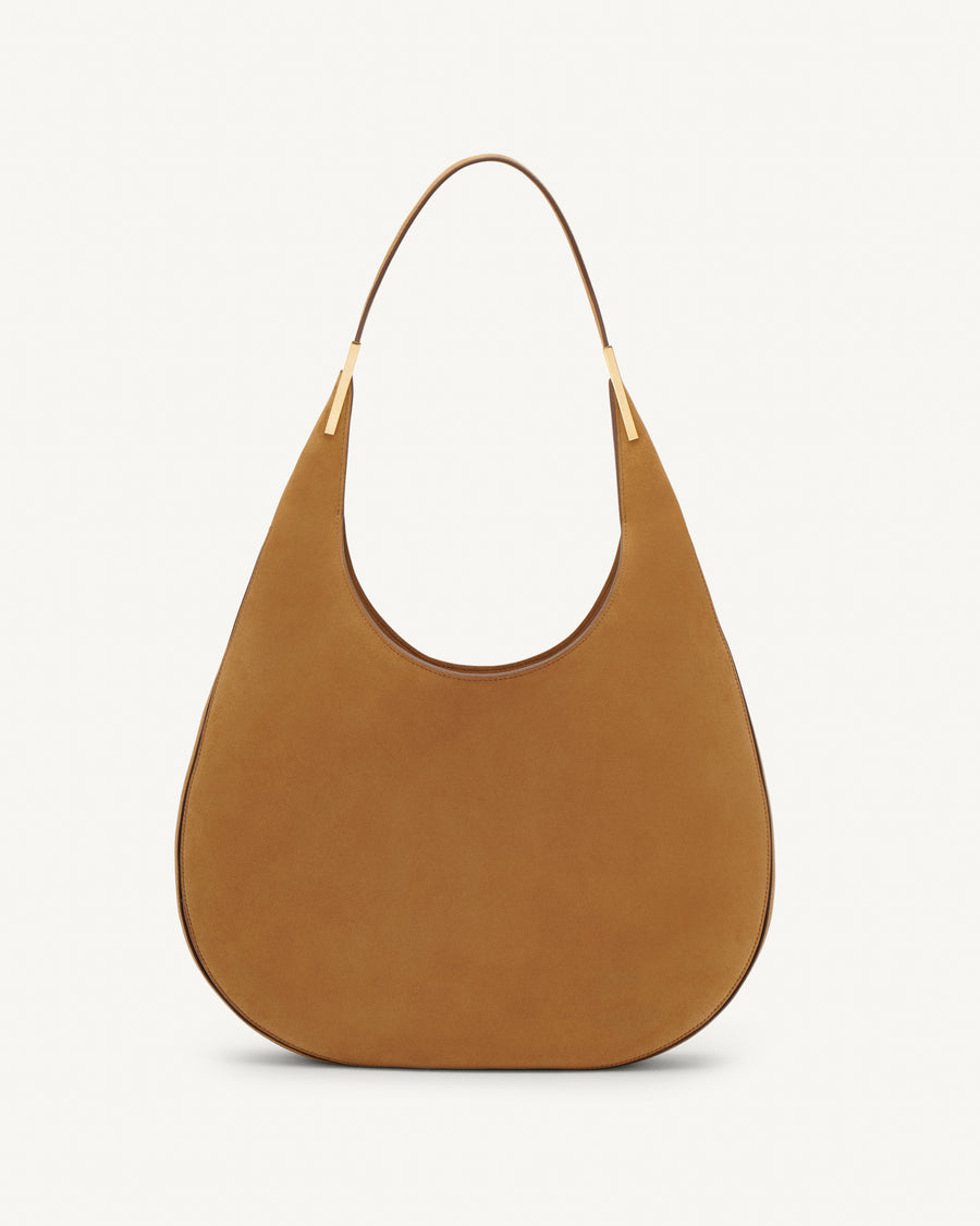 Front view of saddle suede tote bag with gold hardware on a white background