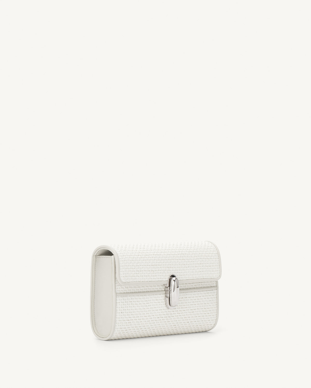 side view of an ivory raffia bag with leather trim with a silver clasp on a white background