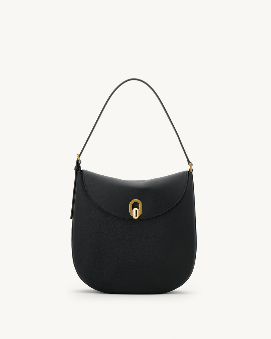 front view of a black leather bag with gold hardware on a white background