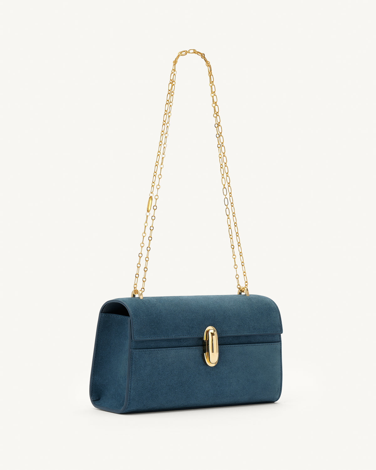 side view of a baltic blue suede handbag with a gold clasp and gold chain on a white background 